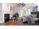 Bright primary bedroom boasts fireplace, ceiling fan, large windows and hardwood floors at 4101 Brookview Se Dr, Atlanta, GA 30339