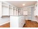 Walk-in closet features island dresser with soft-close drawers and custom-built shelving at 4101 Brookview Se Dr, Atlanta, GA 30339