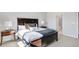 This bedroom features a dark wood bed frame and side tables, neutral walls, and an ensuite bathroom at 605 Vidalia Pkwy, Mcdonough, GA 30252