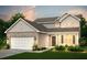 Charming two-story home showcasing brick and shingle siding with a well-manicured lawn at 605 Vidalia Pkwy, Mcdonough, GA 30252