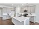 Modern kitchen featuring stainless steel appliances, a large island, and sleek countertops at 605 Vidalia Pkwy, Mcdonough, GA 30252