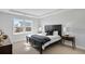 Serene main bedroom with a tray ceiling, large window, and elegant furnishings at 605 Vidalia Pkwy, Mcdonough, GA 30252