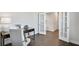 Bright home office with hardwood floors, French doors, and a stylish desk setup at 605 Vidalia Pkwy, Mcdonough, GA 30252