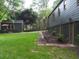 Lush backyard view with a detached garage, an outdoor seating area, and brick-lined garden beds at 1186 Thomas Rd, Decatur, GA 30030