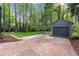 Large backyard features a detached garage, mature trees and room for outdoor activities at 1186 Thomas Rd, Decatur, GA 30030