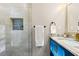 Bathroom view features blue vanity with gold fixtures, tiled shower with inset and stylish design details at 1186 Thomas Rd, Decatur, GA 30030