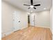 Bedroom with hardwood floors, ceiling fan and ensuite bathroom with glass sliding barn door at 1186 Thomas Rd, Decatur, GA 30030