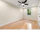 Light-filled bedroom with hardwood floors, ceiling fan and picture window overlooking a forested yard at 1186 Thomas Rd, Decatur, GA 30030