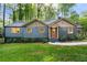 Charming home with attractive siding, a cozy front porch, and a beautifully landscaped front yard at 1186 Thomas Rd, Decatur, GA 30030
