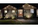 Charming home with attractive lighting, showcasing its beautifully landscaped front yard and welcoming entrance at night at 1186 Thomas Rd, Decatur, GA 30030