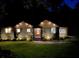Charming home illuminated at night, featuring attractive exterior lighting, landscaping, and a welcoming entrance at 1186 Thomas Rd, Decatur, GA 30030