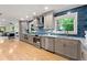 Modern kitchen featuring stainless steel appliances, gray cabinets, and an open layout, filled with natural light at 1186 Thomas Rd, Decatur, GA 30030