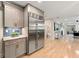 Modern kitchen with stainless steel appliances, gray cabinets, and a view into the open living space at 1186 Thomas Rd, Decatur, GA 30030