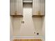 This unfinished laundry room features upper cabinets, wood flooring and utility connections at 1186 Thomas Rd, Decatur, GA 30030