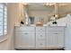 Bright bathroom featuring a double vanity with storage and a large framed mirror at 3677 Sorrel Ln, Duluth, GA 30096