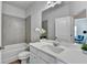 Bathroom with tile surround, white cabinets and vanity plus a tile floor at 3677 Sorrel Ln, Duluth, GA 30096