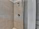 Modern bathroom shower featuring gray tile surround with glass door and sleek fixtures at 3677 Sorrel Ln, Duluth, GA 30096