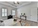 Spacious bedroom featuring a tray ceiling, two windows with shutters, and a doorway at 3677 Sorrel Ln, Duluth, GA 30096
