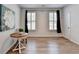 Bright bedroom with wood-look floors, two windows with shutters, and white walls, perfect for relaxing at 3677 Sorrel Ln, Duluth, GA 30096