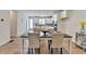 Open dining room with views of the modern kitchen and island featuring granite countertops and stainless appliances at 3677 Sorrel Ln, Duluth, GA 30096