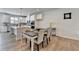 Open concept dining area with white kitchen, island, and stainless appliances in a well-lit modern home at 3677 Sorrel Ln, Duluth, GA 30096