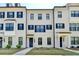 Charming white brick townhome featuring black shutters, black trim, and a stylish dark blue front door at 3677 Sorrel Ln, Duluth, GA 30096