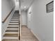 Inviting hallway featuring a staircase with wood railings and elegant wood-look floors, creating a warm ambiance at 3677 Sorrel Ln, Duluth, GA 30096