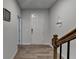 Bright hallway featuring a staircase with wood railings and modern wood-look floors, offering a welcoming feel at 3677 Sorrel Ln, Duluth, GA 30096