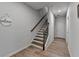 Welcoming hallway featuring a staircase with wood railings and stylish wood-look floors, offering a warm ambiance at 3677 Sorrel Ln, Duluth, GA 30096