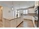 Stylish kitchen featuring white cabinets, granite counters, stainless steel appliances, and a large island at 3677 Sorrel Ln, Duluth, GA 30096
