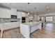 Modern kitchen showcases white cabinets, stainless appliances, and a granite island at 3677 Sorrel Ln, Duluth, GA 30096