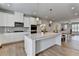 Modern kitchen showcases white cabinets, stainless appliances, and a granite island at 3677 Sorrel Ln, Duluth, GA 30096