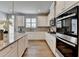 Modern kitchen featuring white cabinets, stainless appliances, granite counters and lots of natural light at 3677 Sorrel Ln, Duluth, GA 30096