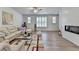 Bright living room with a decorative fireplace and large windows at 3677 Sorrel Ln, Duluth, GA 30096