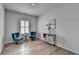 Bright sitting area features hardwood floors, natural light, decor and stylish blue chairs at 3677 Sorrel Ln, Duluth, GA 30096