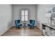 Bright sitting area features hardwood floors, natural light, decor, stylish chairs, and a small table at 3677 Sorrel Ln, Duluth, GA 30096