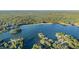 Aerial view showcases the lake community with lush trees and several boats on the water at 8083 Cypress Ct, Villa Rica, GA 30180