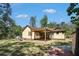 Charming home with a wooden pergola that provides shade on the patio overlooking the spacious, tree-filled backyard at 8083 Cypress Ct, Villa Rica, GA 30180