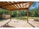 Covered wooden pergola overlooking spacious, tree-lined backyard with shed at 8083 Cypress Ct, Villa Rica, GA 30180