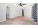This large bedroom has neutral walls and carpet, a fan, and multiple entry points at 8083 Cypress Ct, Villa Rica, GA 30180