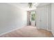 An airy bedroom with carpet, a fan, and natural light from the window at 8083 Cypress Ct, Villa Rica, GA 30180