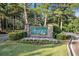 Fairfield Plantation entrance sign with stone base and well manicured flower bed and bushes at 8083 Cypress Ct, Villa Rica, GA 30180