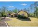 Charming one-story home featuring green lawn, mature trees, and attached garage at 8083 Cypress Ct, Villa Rica, GA 30180