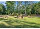 A large fountain surrounded by a green lawn and mature trees in the community at 8083 Cypress Ct, Villa Rica, GA 30180