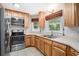 This kitchen features wooden cabinets, stainless steel appliances and stylish countertops and sink at 8083 Cypress Ct, Villa Rica, GA 30180