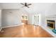 Bright living room boasts hardwood floors, a ceiling fan, and a cozy fireplace at 8083 Cypress Ct, Villa Rica, GA 30180