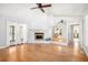 Living room features hardwood floors, a fireplace, and bright windows with lots of natural light at 8083 Cypress Ct, Villa Rica, GA 30180