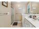 Neutral bathroom featuring a glass shower, vanity and natural light from the window at 3215 Rose Petal Ln, Powder Springs, GA 30127