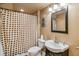 Cozy bathroom featuring a shower with patterned curtain, modern sink, mirror, and neutral color scheme at 3215 Rose Petal Ln, Powder Springs, GA 30127