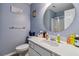 Clean bathroom with a round mirror, a vanity and shower with a shower curtain at 3215 Rose Petal Ln, Powder Springs, GA 30127